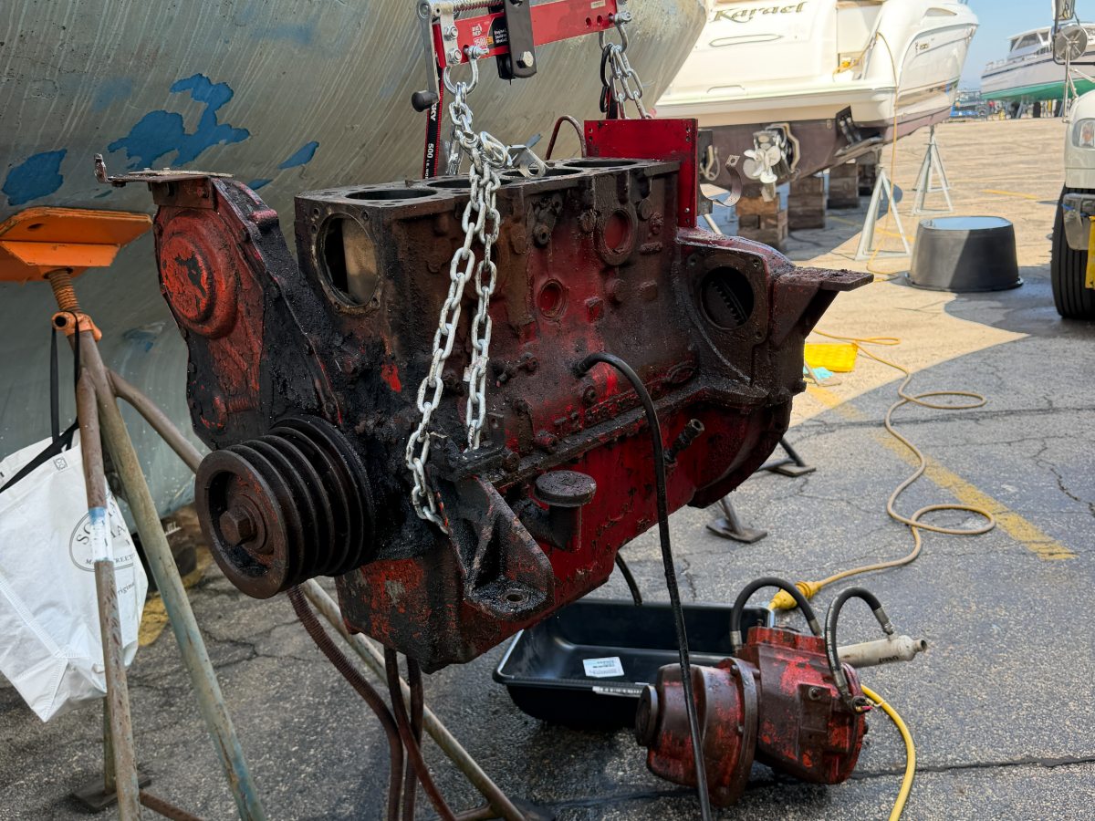 An original marine diesel lifted out of a boat in the yard